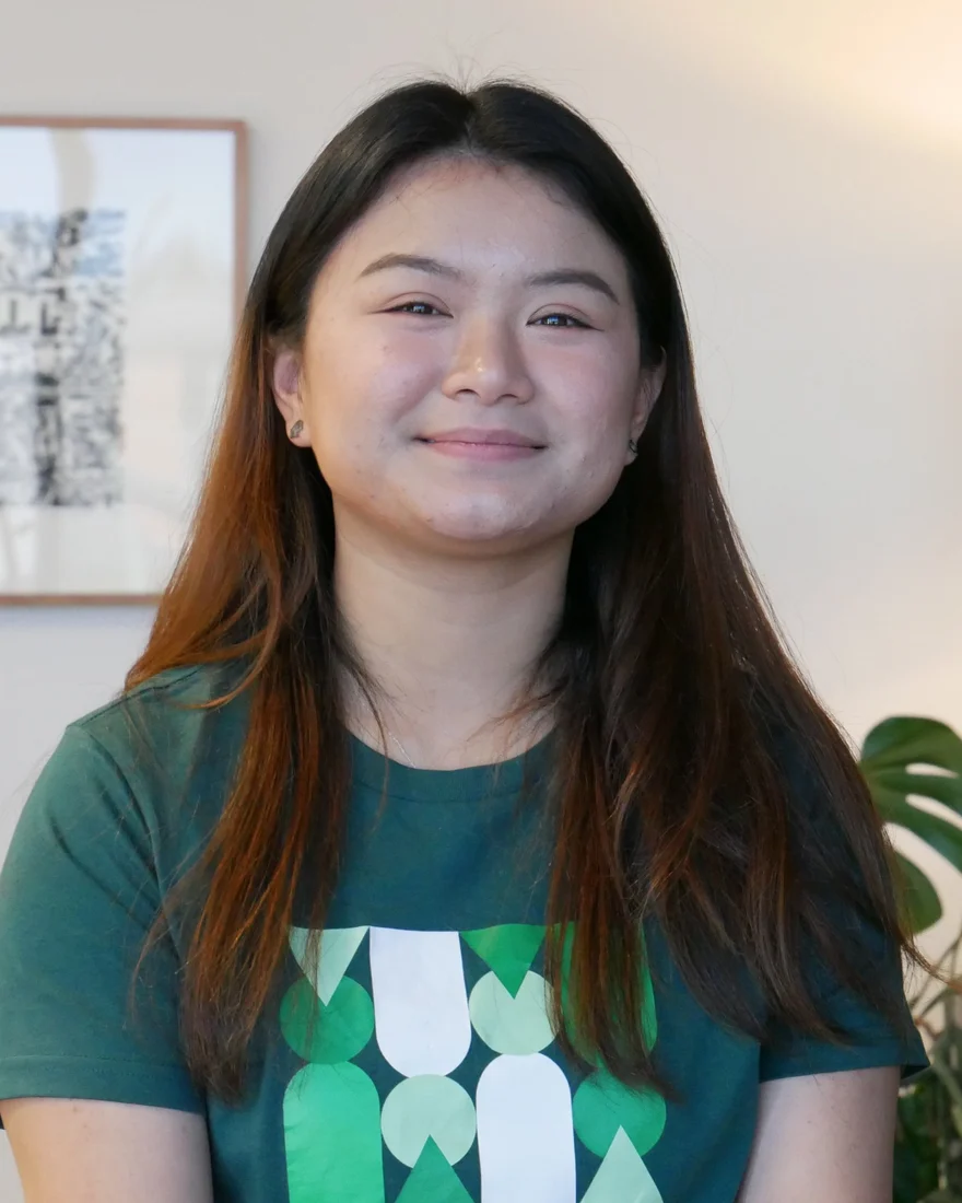 Portrait of Thida An, smiling, in a green t-shirt